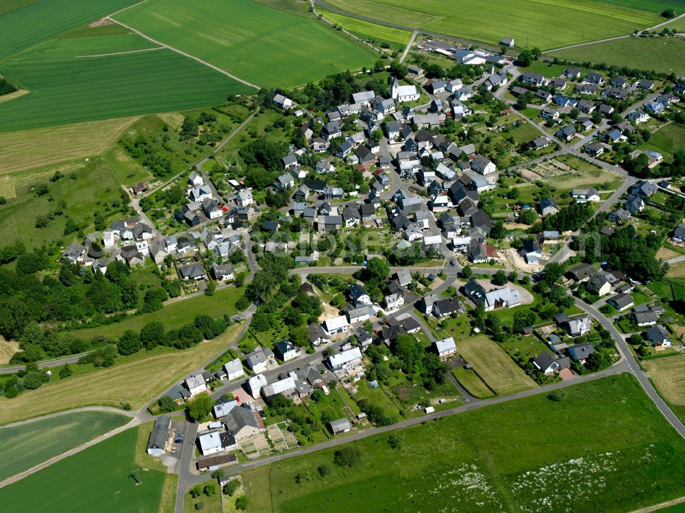 Aerial image Bell (Hunsrück) - Agricultural land and field boundaries surround the settlement area of the village in Bell (Hunsrück) in the state Rhineland-Palatinate, Germany