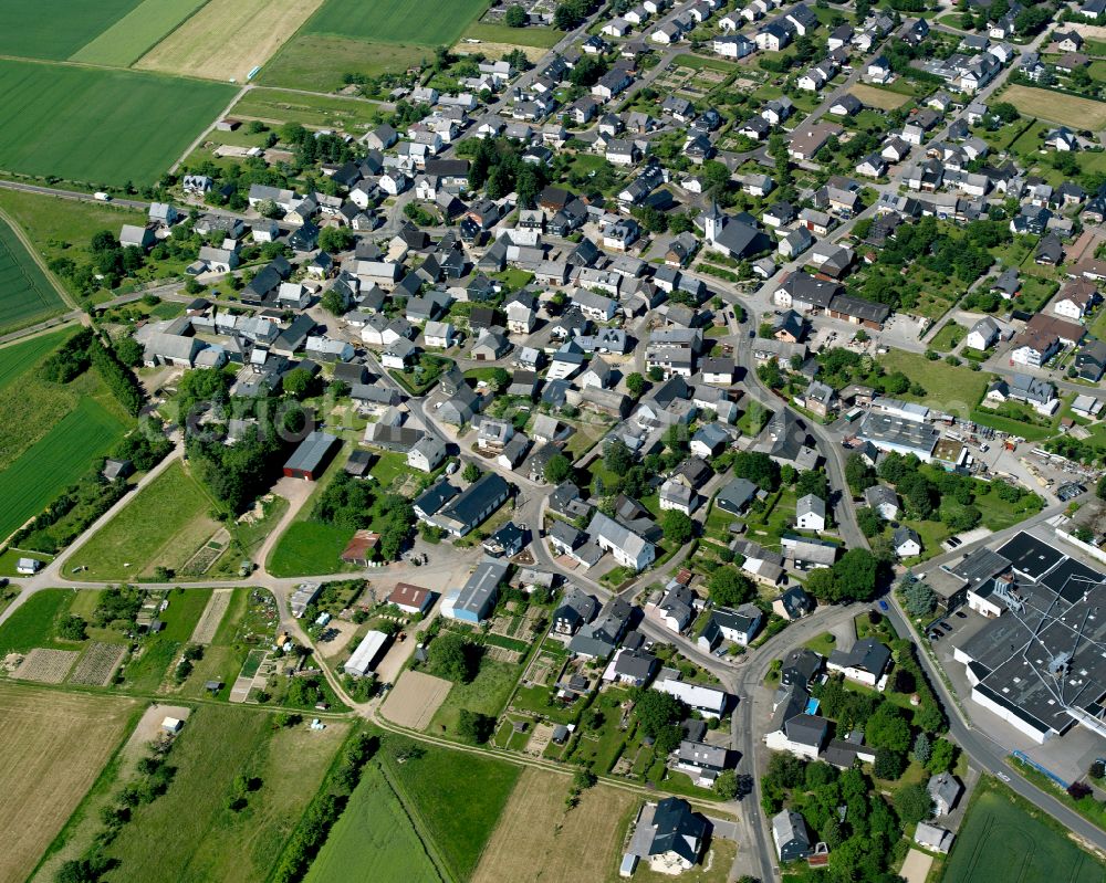 Beltheim from above - Agricultural land and field boundaries surround the settlement area of the village in Beltheim in the state Rhineland-Palatinate, Germany