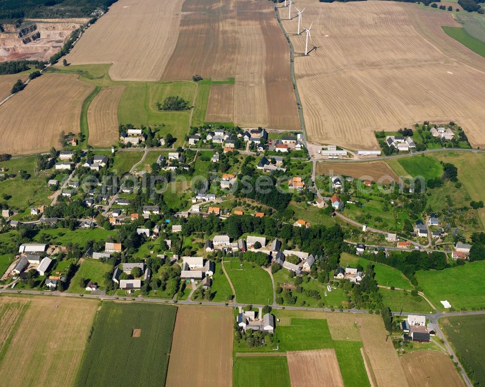 Berbersdorf from above - Agricultural land and field boundaries surround the settlement area of the village in Berbersdorf in the state Saxony, Germany