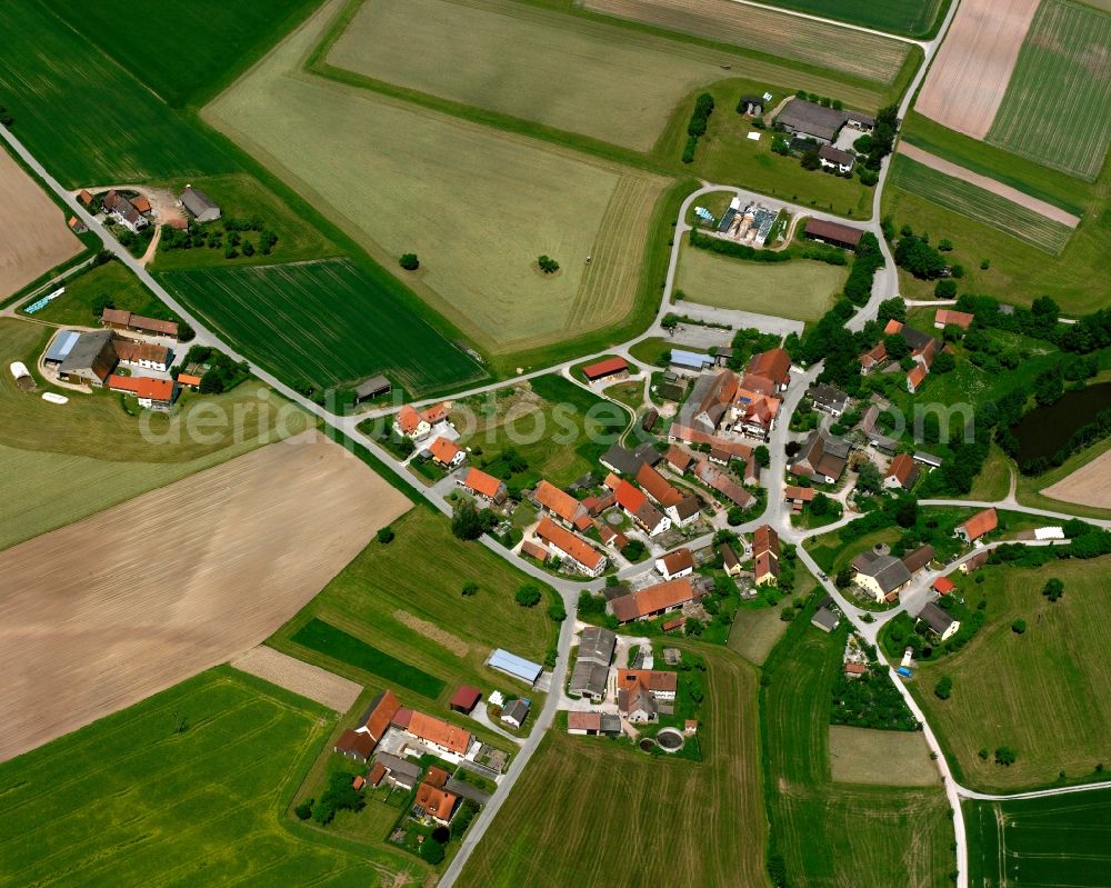 Bernau from above - Agricultural land and field boundaries surround the settlement area of the village in Bernau in the state Bavaria, Germany