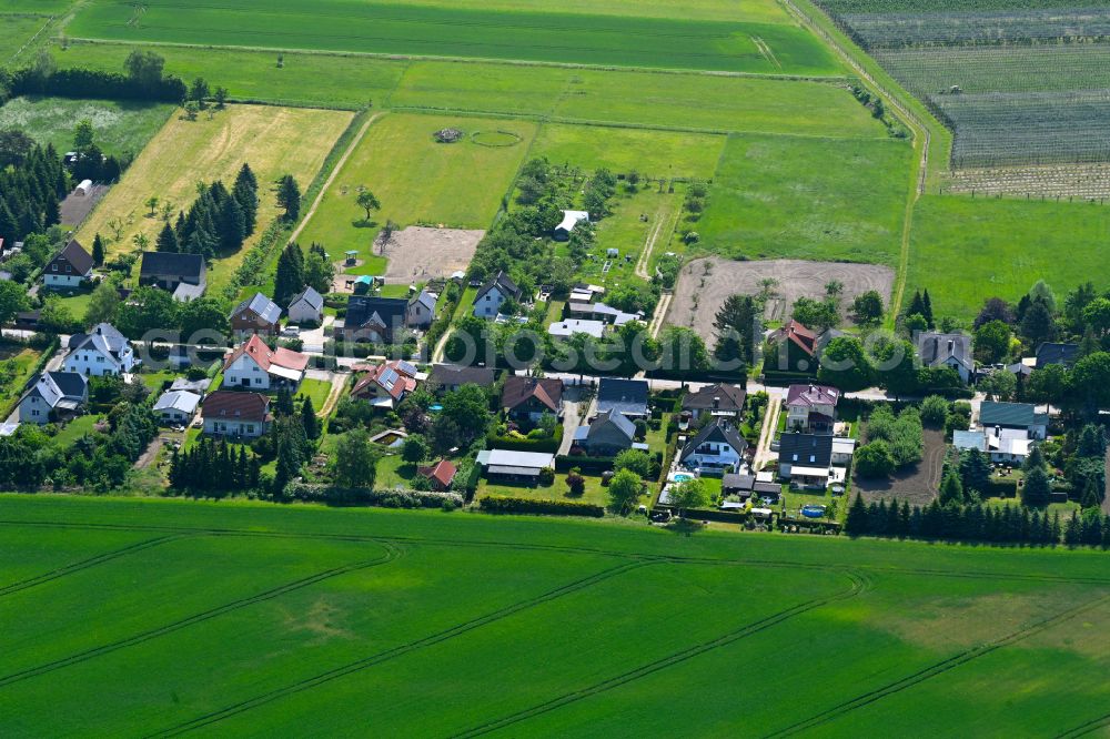 Aerial image Bernau bei Berlin - Agricultural land and field boundaries surround the settlement area of the village in Bernau in the state Brandenburg, Germany