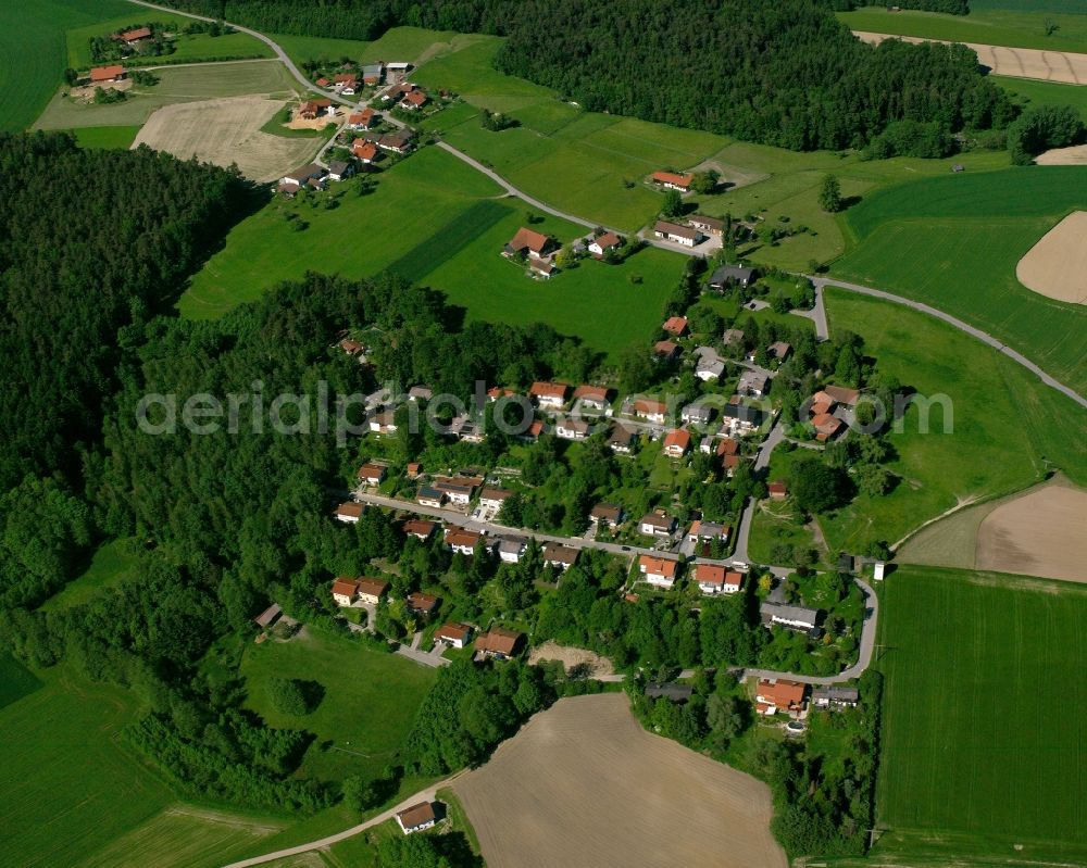 Berndlberg from above - Agricultural land and field boundaries surround the settlement area of the village in Berndlberg in the state Bavaria, Germany