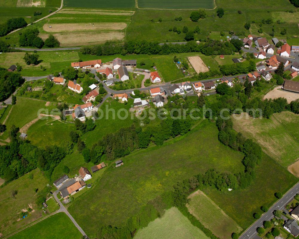 Aerial image Bernsburg - Agricultural land and field boundaries surround the settlement area of the village in Bernsburg in the state Hesse, Germany