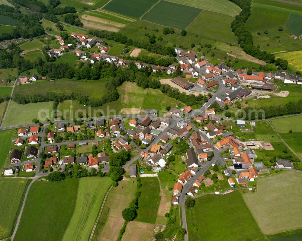 Aerial photograph Bernsburg - Agricultural land and field boundaries surround the settlement area of the village in Bernsburg in the state Hesse, Germany