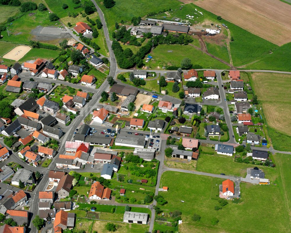 Aerial photograph Bernsfeld - Agricultural land and field boundaries surround the settlement area of the village in Bernsfeld in the state Hesse, Germany