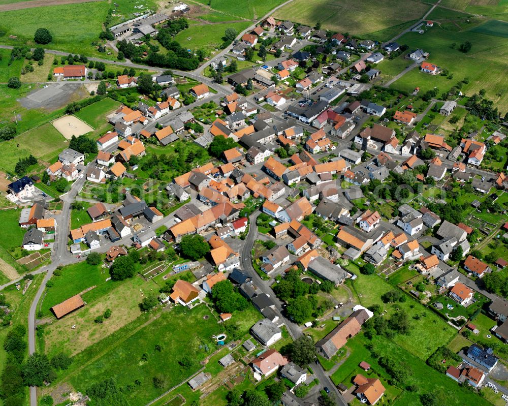 Bernsfeld from above - Agricultural land and field boundaries surround the settlement area of the village in Bernsfeld in the state Hesse, Germany