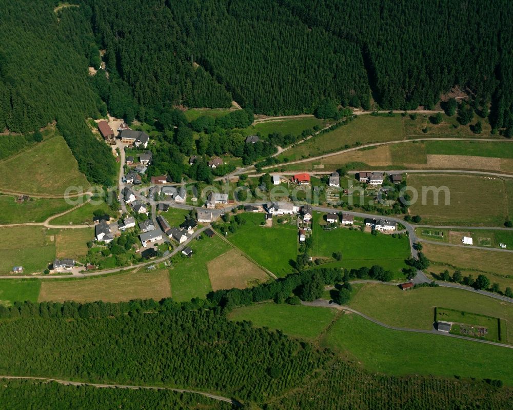 Bernshausen from the bird's eye view: Agricultural land and field boundaries surround the settlement area of the village in Bernshausen in the state North Rhine-Westphalia, Germany