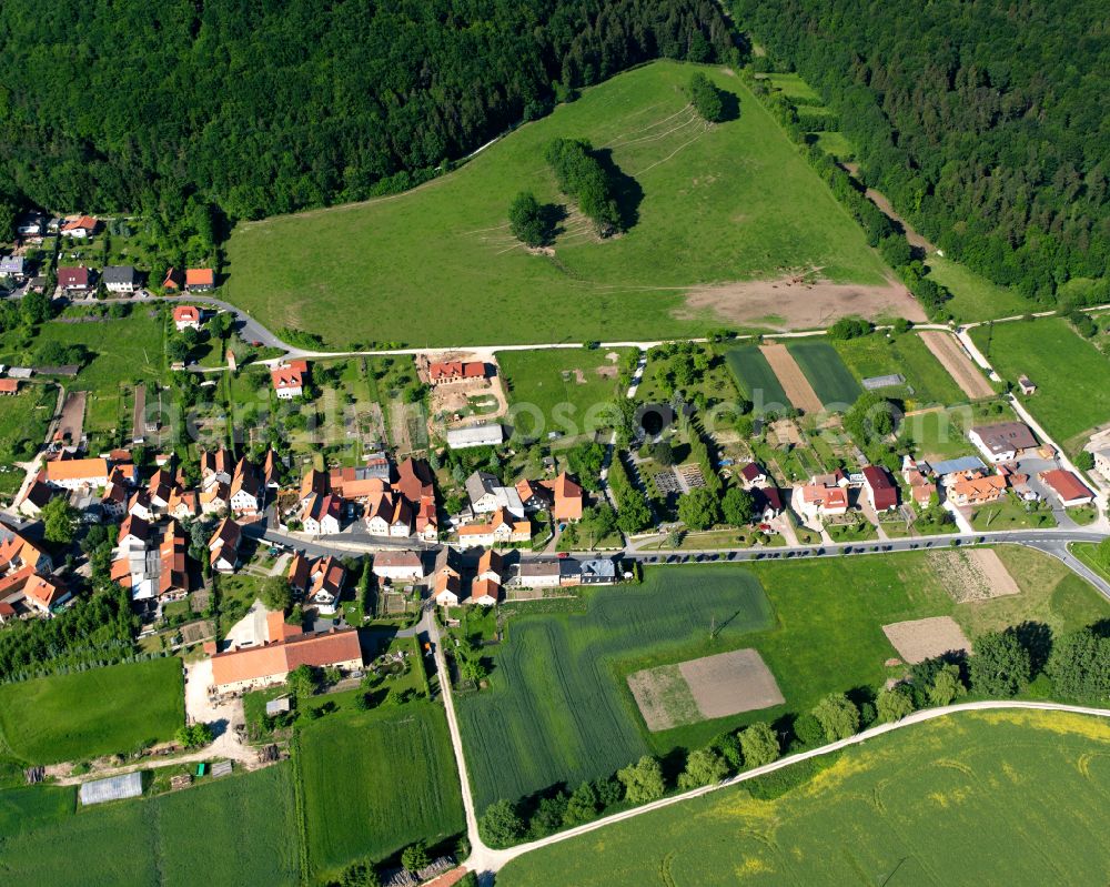 Bernterode (bei Heilbad Heiligenstadt) from the bird's eye view: Agricultural land and field boundaries surround the settlement area of the village in Bernterode (bei Heilbad Heiligenstadt) in the state Thuringia, Germany