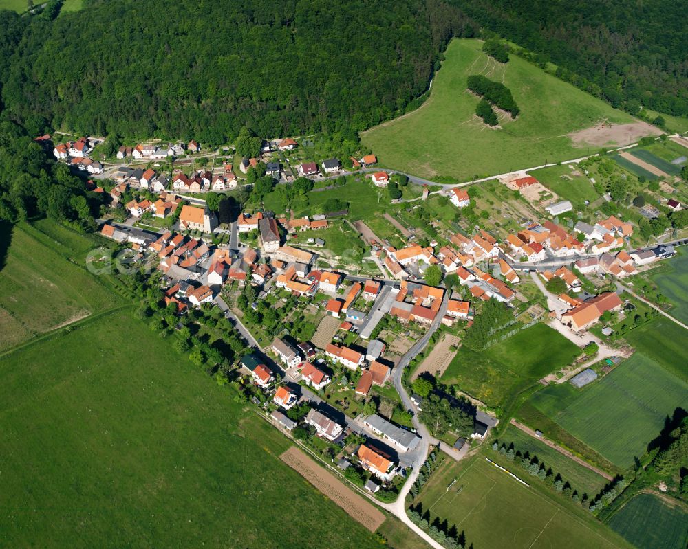 Aerial image Bernterode (bei Heilbad Heiligenstadt) - Agricultural land and field boundaries surround the settlement area of the village in Bernterode (bei Heilbad Heiligenstadt) in the state Thuringia, Germany