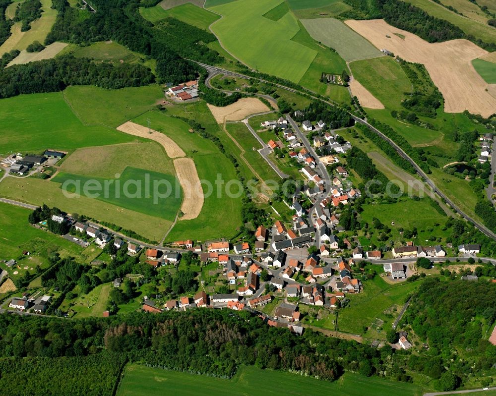 Aerial image Berschweiler bei Baumholder - Agricultural land and field boundaries surround the settlement area of the village in Berschweiler bei Baumholder in the state Rhineland-Palatinate, Germany