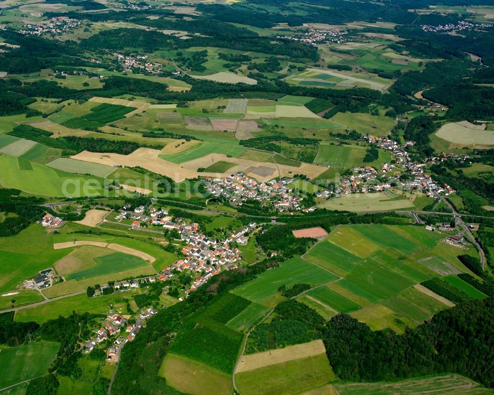 Aerial image Berschweiler bei Baumholder - Agricultural land and field boundaries surround the settlement area of the village in Berschweiler bei Baumholder in the state Rhineland-Palatinate, Germany