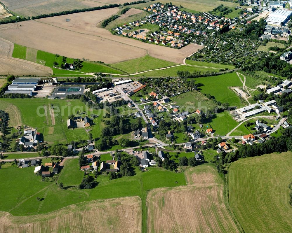 Berthelsdorf from above - Agricultural land and field boundaries surround the settlement area of the village in Berthelsdorf in the state Saxony, Germany