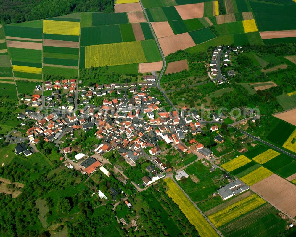 Aerial image Bettenhausen - Agricultural land and field boundaries surround the settlement area of the village in Bettenhausen in the state Hesse, Germany