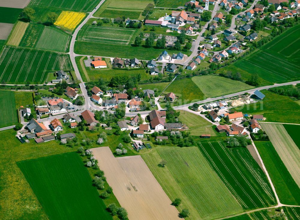 Bettighofen from above - Agricultural land and field boundaries surround the settlement area of the village in Bettighofen in the state Baden-Wuerttemberg, Germany