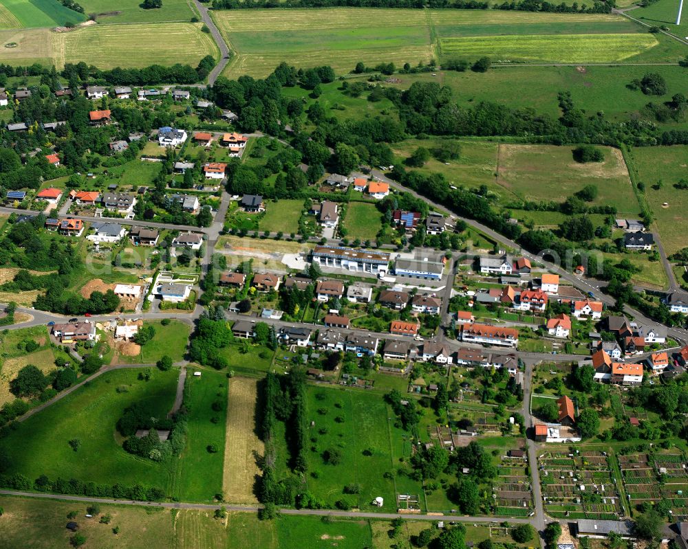 Betzenrod from above - Agricultural land and field boundaries surround the settlement area of the village in Betzenrod in the state Hesse, Germany