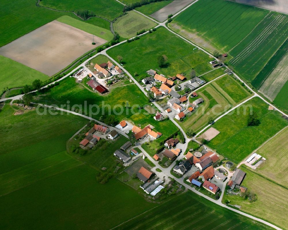 Bieg from the bird's eye view: Agricultural land and field boundaries surround the settlement area of the village in Bieg in the state Bavaria, Germany