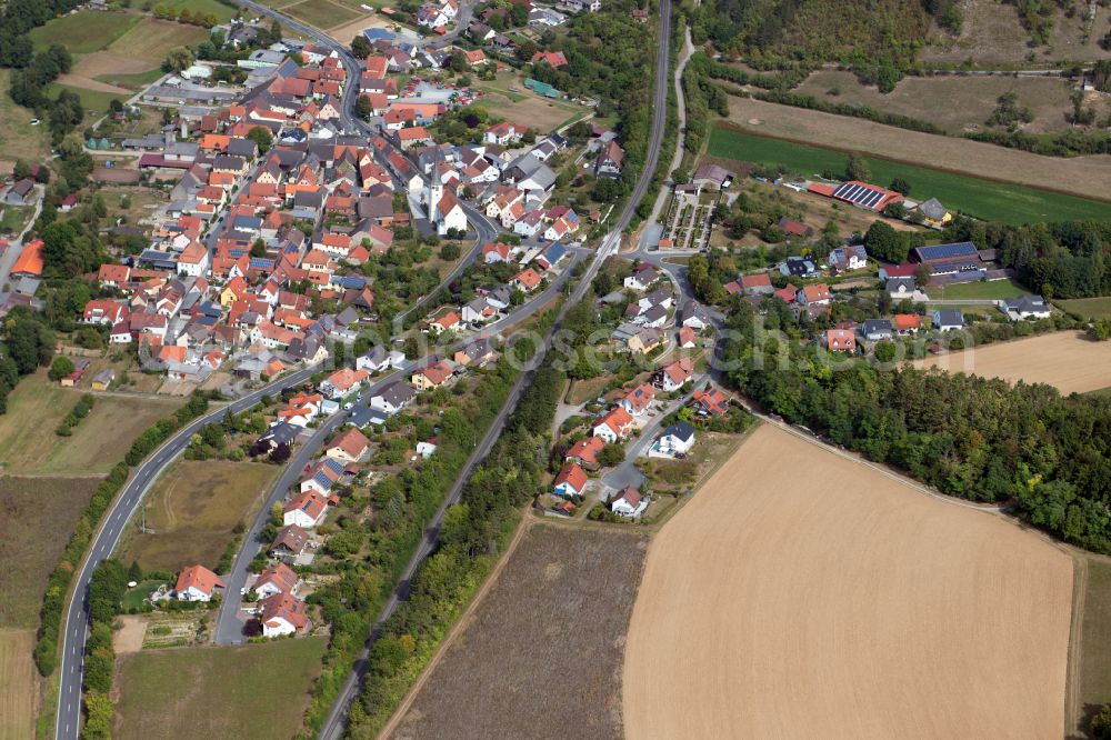 Aerial photograph Binsfeld - Agricultural land and field boundaries surround the settlement area of the village in Binsfeld in the state Bavaria, Germany