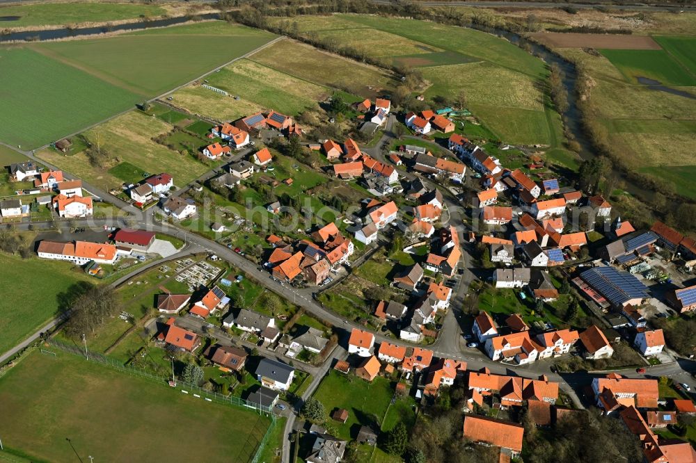 Binsförth from above - Agricultural land and field boundaries surround the settlement area of the village in Binsförth in the state Hesse, Germany