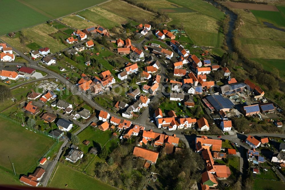 Binsförth from the bird's eye view: Agricultural land and field boundaries surround the settlement area of the village in Binsförth in the state Hesse, Germany