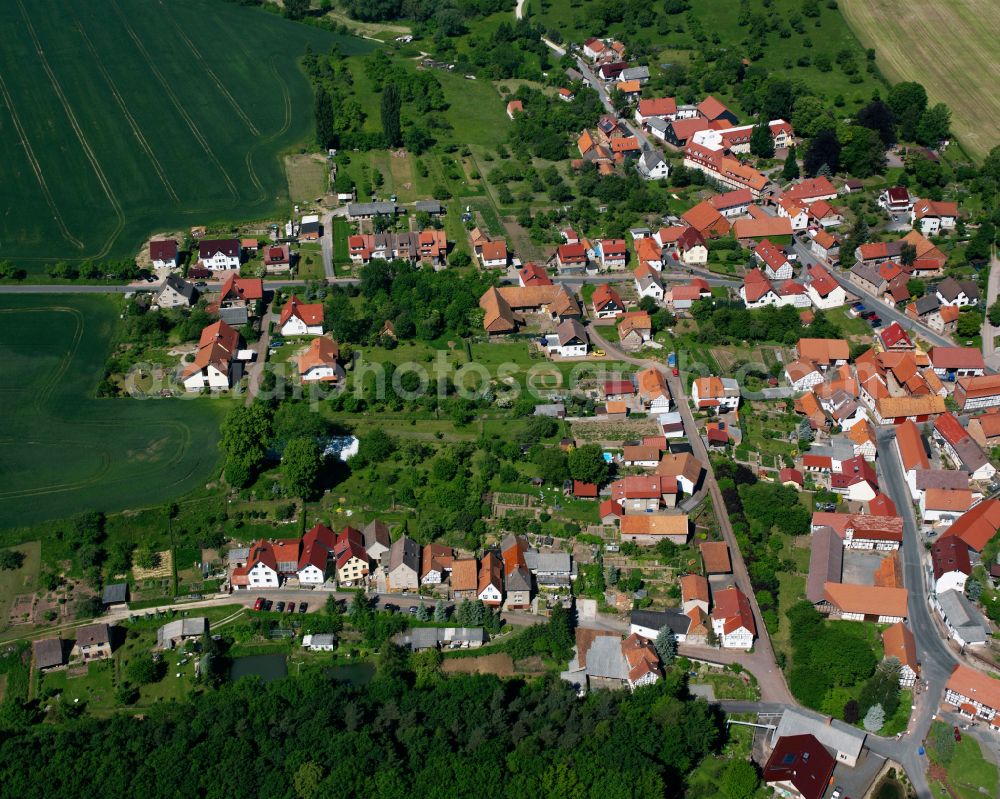 Birkenfelde from above - Agricultural land and field boundaries surround the settlement area of the village in Birkenfelde in the state Thuringia, Germany