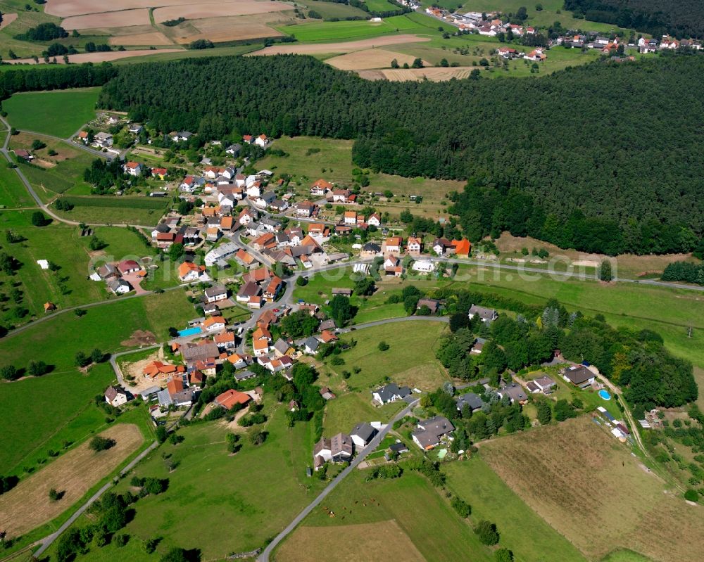 Birkert from the bird's eye view: Agricultural land and field boundaries surround the settlement area of the village in Birkert in the state Hesse, Germany