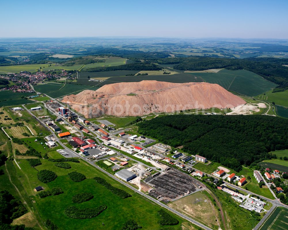 Bischofferode from above - Agricultural land and field boundaries surround the settlement area of the village in Bischofferode in the state Thuringia, Germany