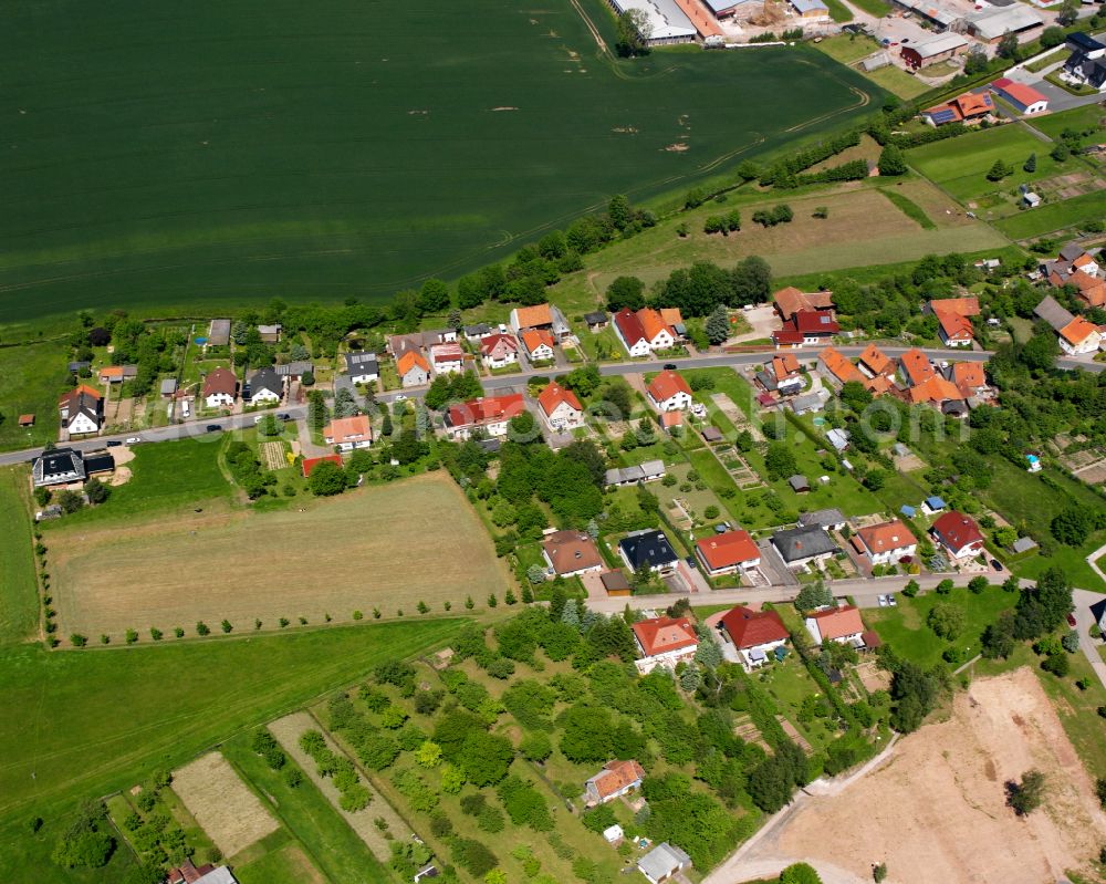 Aerial photograph Bischofferode - Agricultural land and field boundaries surround the settlement area of the village in Bischofferode in the state Thuringia, Germany