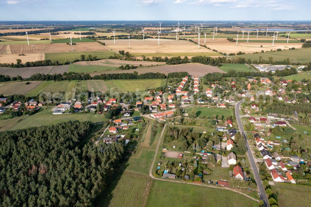 Bliesdorf from the bird's eye view: Agricultural land and field boundaries surround the settlement area of the village in Bliesdorf in the state Brandenburg, Germany