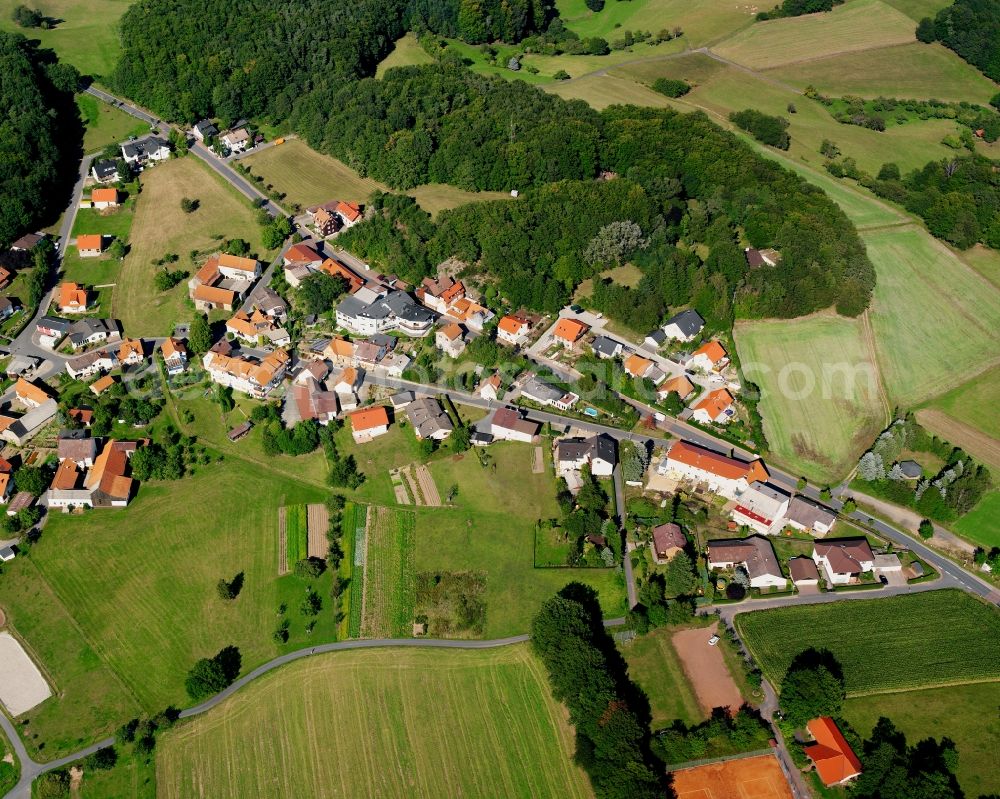 Böllstein from above - Agricultural land and field boundaries surround the settlement area of the village in Böllstein in the state Hesse, Germany