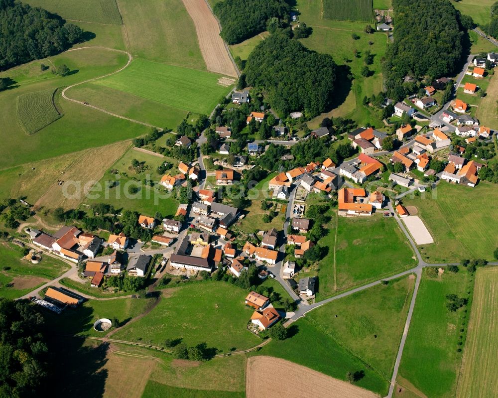 Böllstein from the bird's eye view: Agricultural land and field boundaries surround the settlement area of the village in Böllstein in the state Hesse, Germany