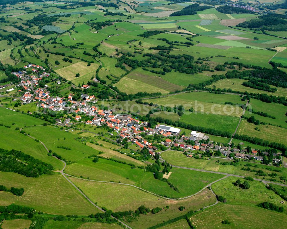 Bobenhausen from above - Agricultural land and field boundaries surround the settlement area of the village in Bobenhausen in the state Hesse, Germany