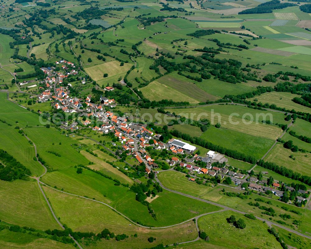 Bobenhausen from above - Agricultural land and field boundaries surround the settlement area of the village in Bobenhausen in the state Hesse, Germany