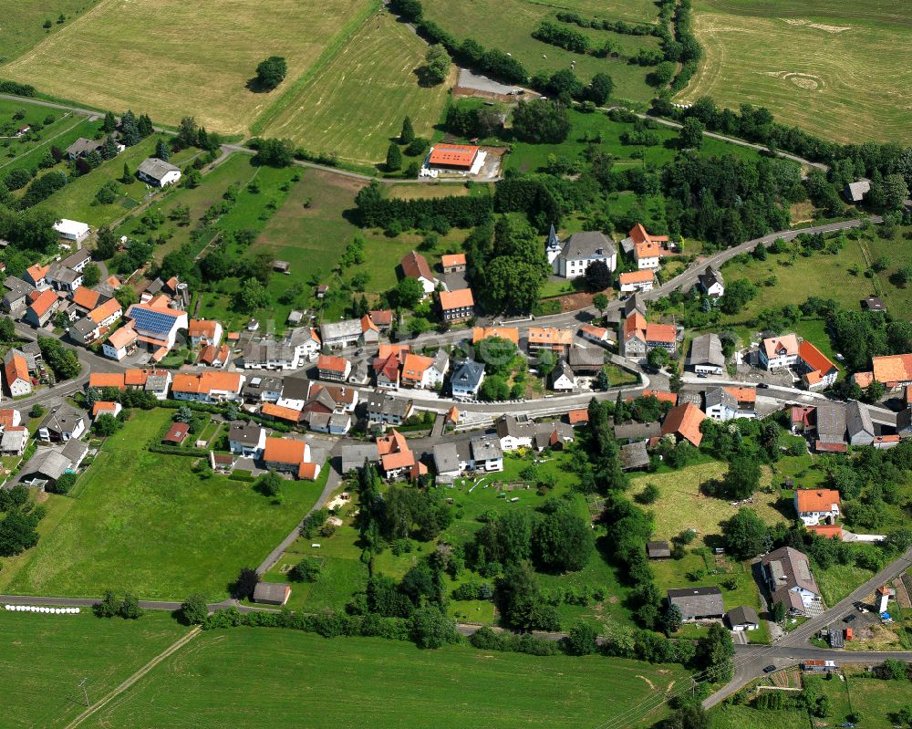 Bobenhausen from above - Agricultural land and field boundaries surround the settlement area of the village in Bobenhausen in the state Hesse, Germany