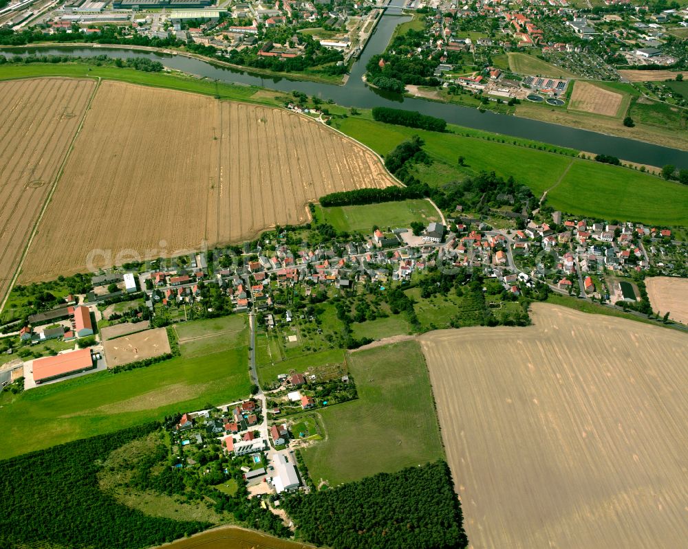 Bobersen from above - Agricultural land and field boundaries surround the settlement area of the village in Bobersen in the state Saxony, Germany