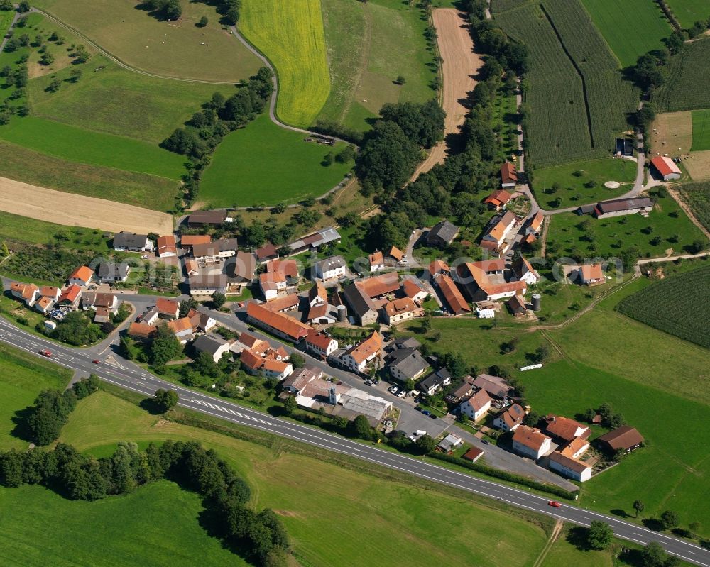 Bockenrod from above - Agricultural land and field boundaries surround the settlement area of the village in Bockenrod in the state Hesse, Germany