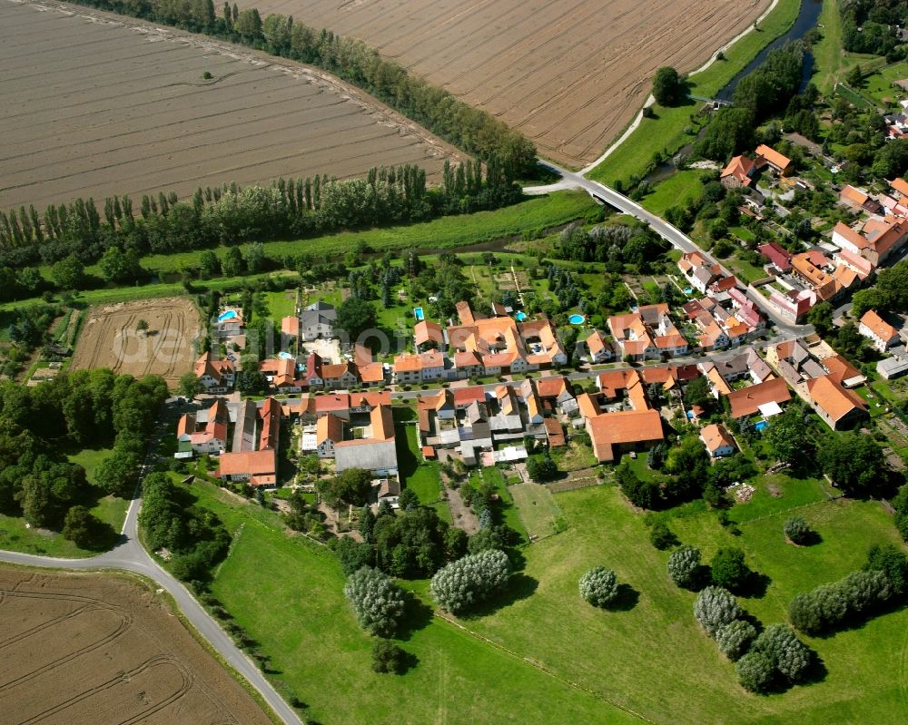 Bollstedt from the bird's eye view: Agricultural land and field boundaries surround the settlement area of the village in Bollstedt in the state Thuringia, Germany