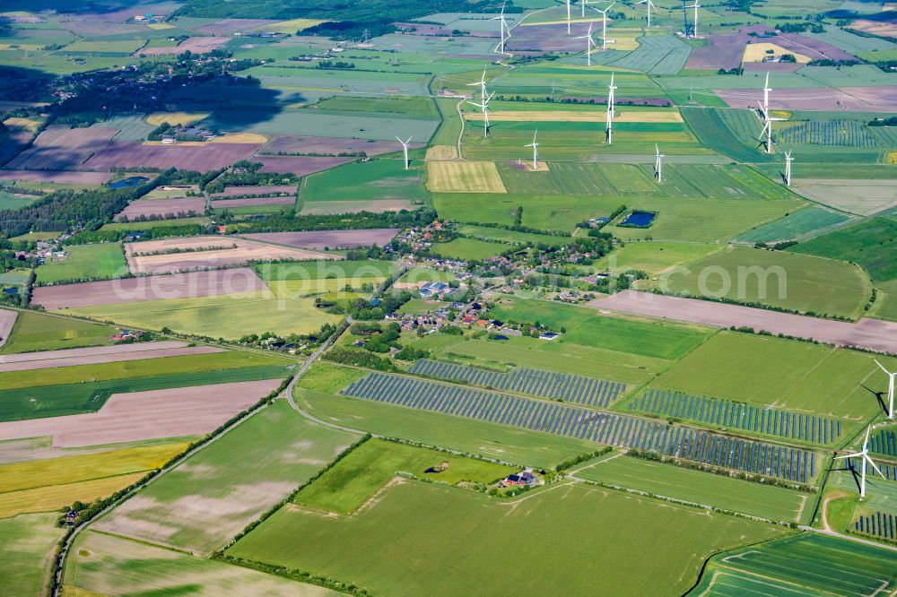 Bosbüll from the bird's eye view: Agricultural land and field boundaries surround the settlement area of the village on street Hauptstrasse in Bosbuell in the state Schleswig-Holstein, Germany