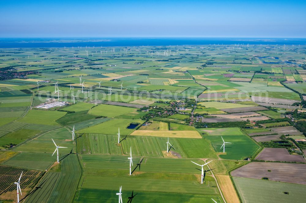 Bosbüll from the bird's eye view: Agricultural land and field boundaries surround the settlement area of the village on street Hauptstrasse in Bosbuell in the state Schleswig-Holstein, Germany