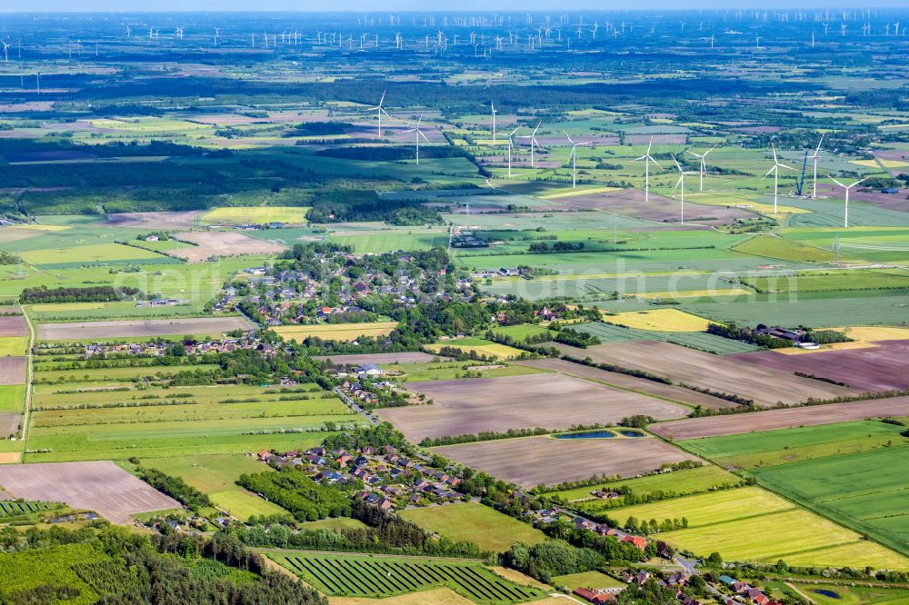 Braderup from above - Agricultural land and field boundaries surround the settlement area of the village in Braderup in the state Schleswig-Holstein, Germany