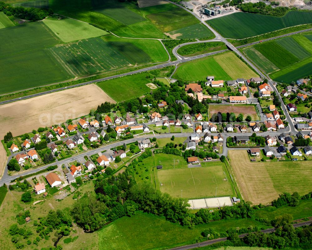 Aerial image Brauerschwend - Agricultural land and field boundaries surround the settlement area of the village in Brauerschwend in the state Hesse, Germany