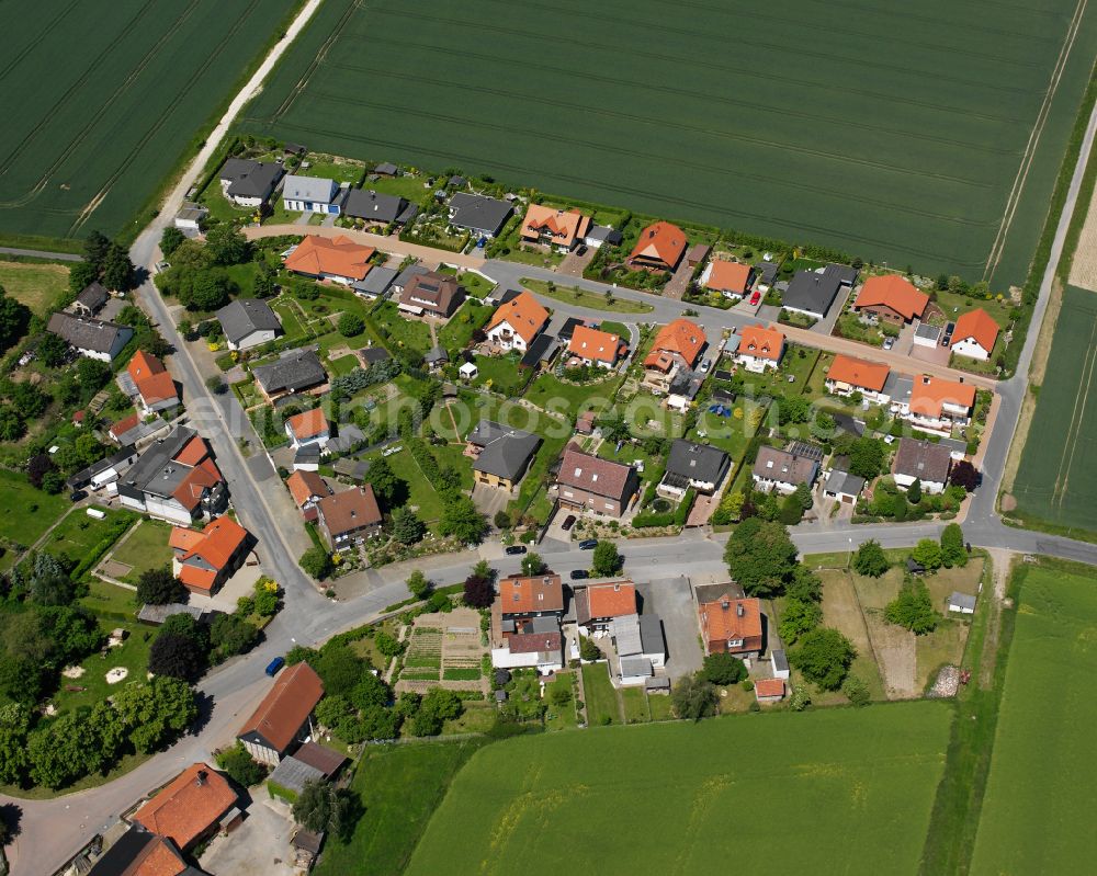 Bredelem from the bird's eye view: Agricultural land and field boundaries surround the settlement area of the village in Bredelem in the state Lower Saxony, Germany