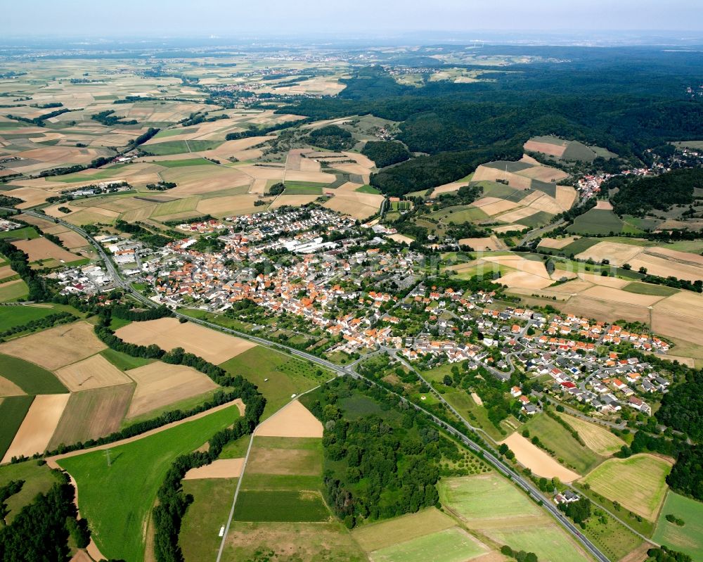 Brensbach from above - Agricultural land and field boundaries surround the settlement area of the village in Brensbach in the state Hesse, Germany