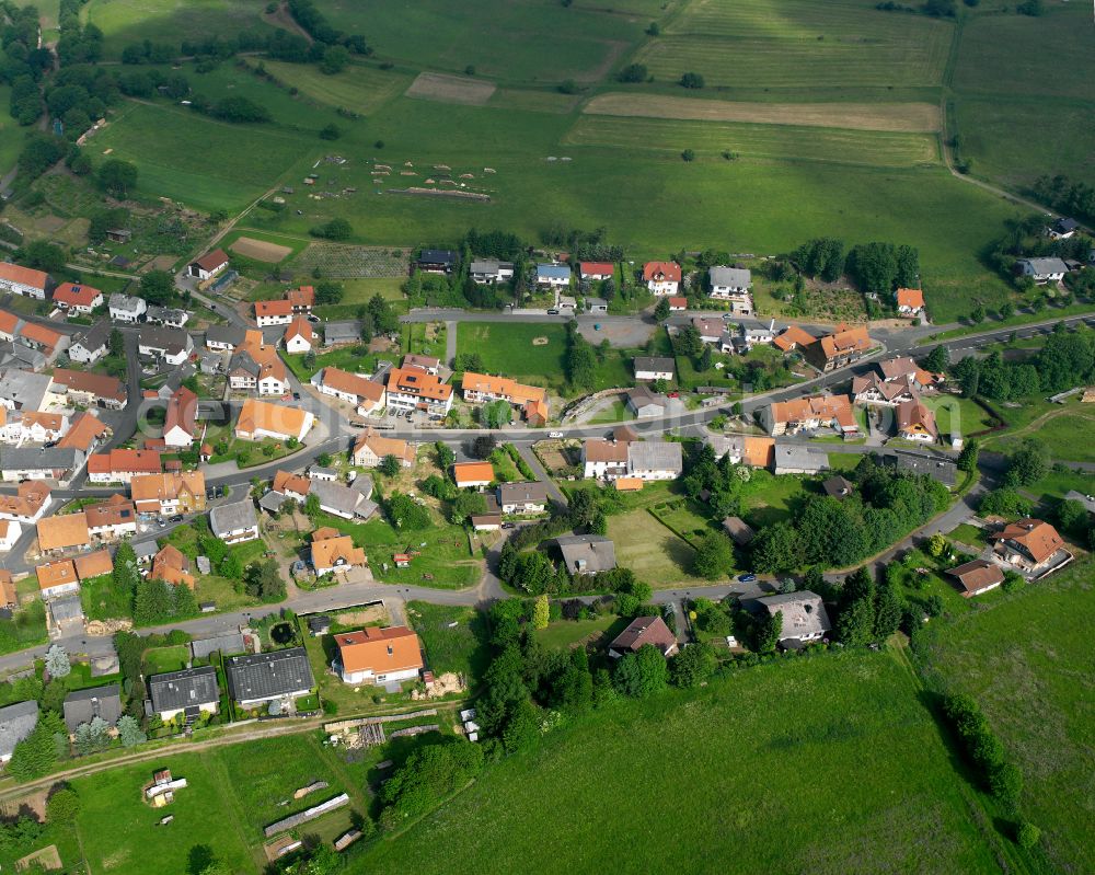 Breungeshain from the bird's eye view: Agricultural land and field boundaries surround the settlement area of the village in Breungeshain in the state Hesse, Germany