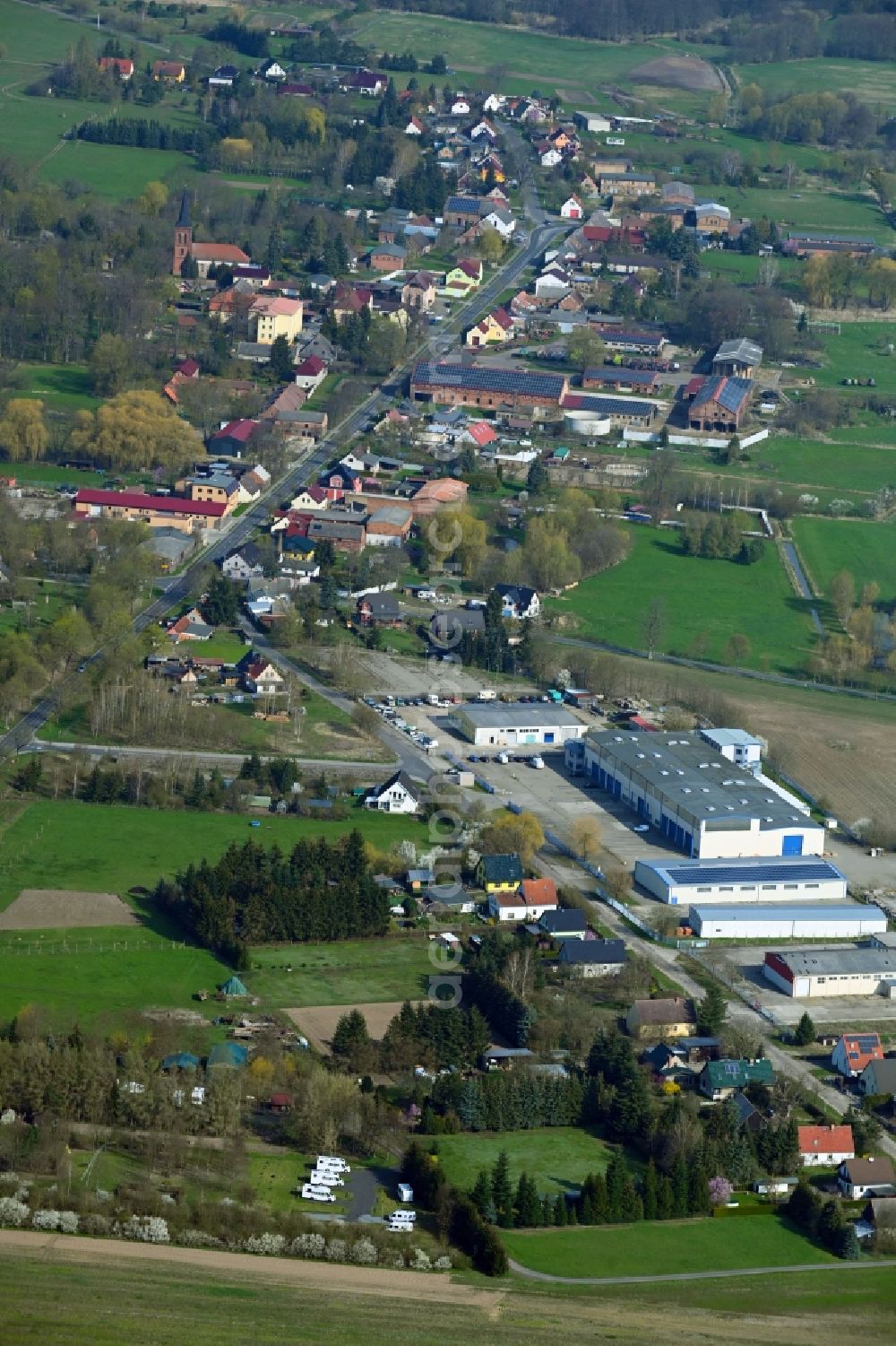 Breydin from the bird's eye view: Agricultural land and field boundaries surround the settlement area of the village in Breydin in the state Brandenburg, Germany