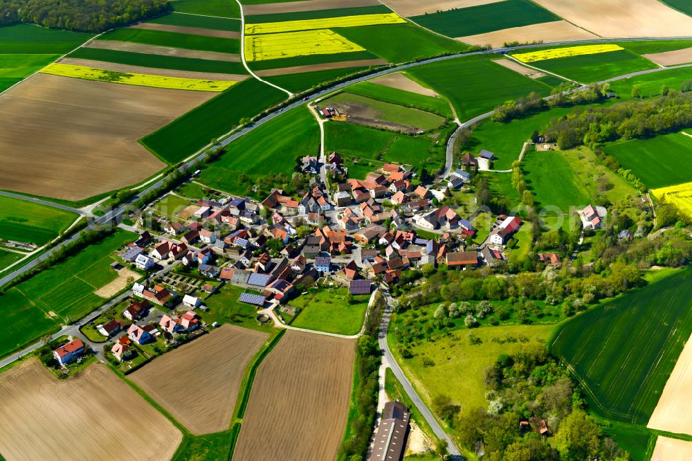 Aerial image Brünnau - Agricultural land and field boundaries surround the settlement area of the village in Brünnau in the state Bavaria, Germany