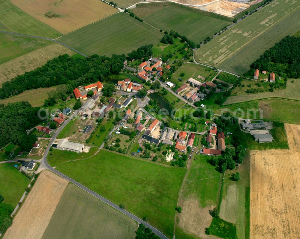 Brößnitz from above - Agricultural land and field boundaries surround the settlement area of the village in Brößnitz in the state Saxony, Germany