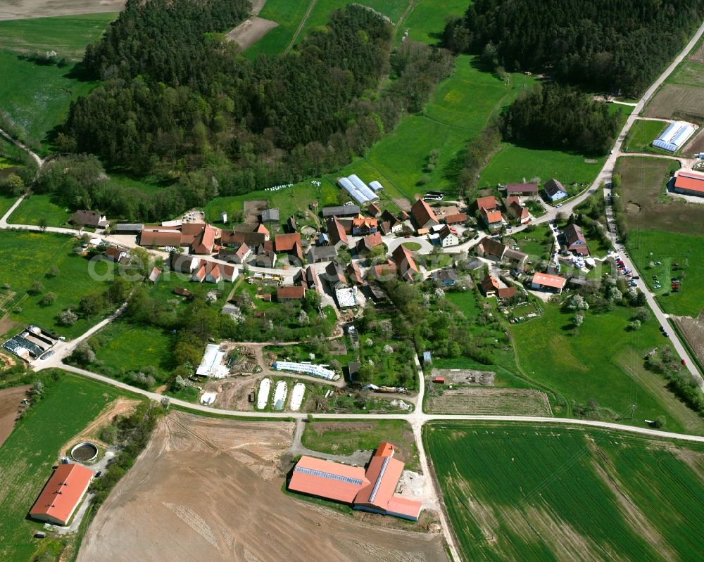 Büschelbach from the bird's eye view: Agricultural land and field boundaries surround the settlement area of the village in Büschelbach in the state Bavaria, Germany