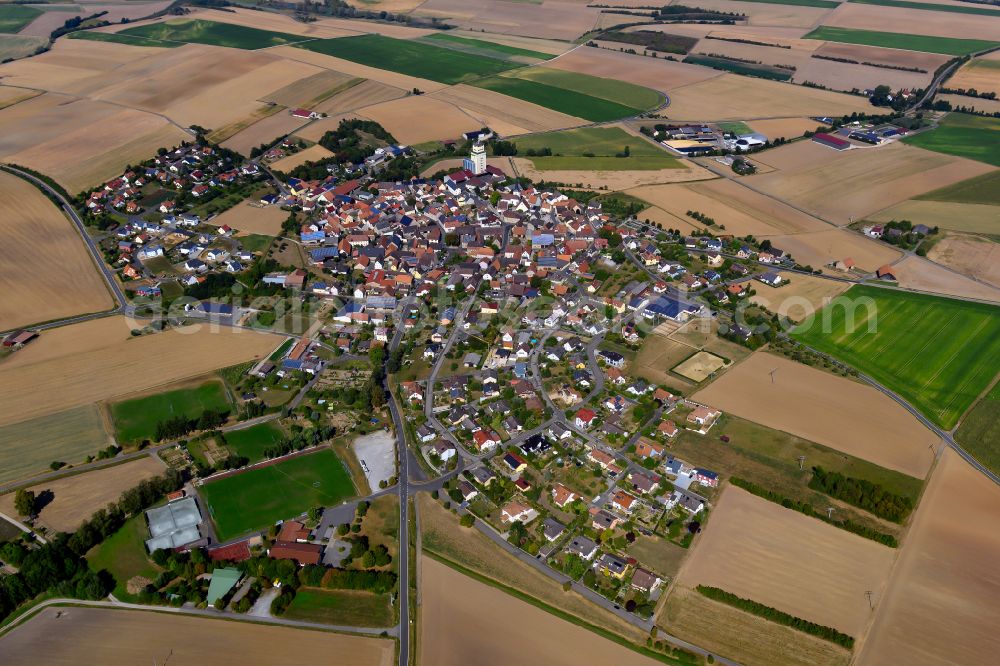 Aerial photograph Bütthard - Agricultural land and field boundaries surround the settlement area of the village in Bütthard in the state Bavaria, Germany