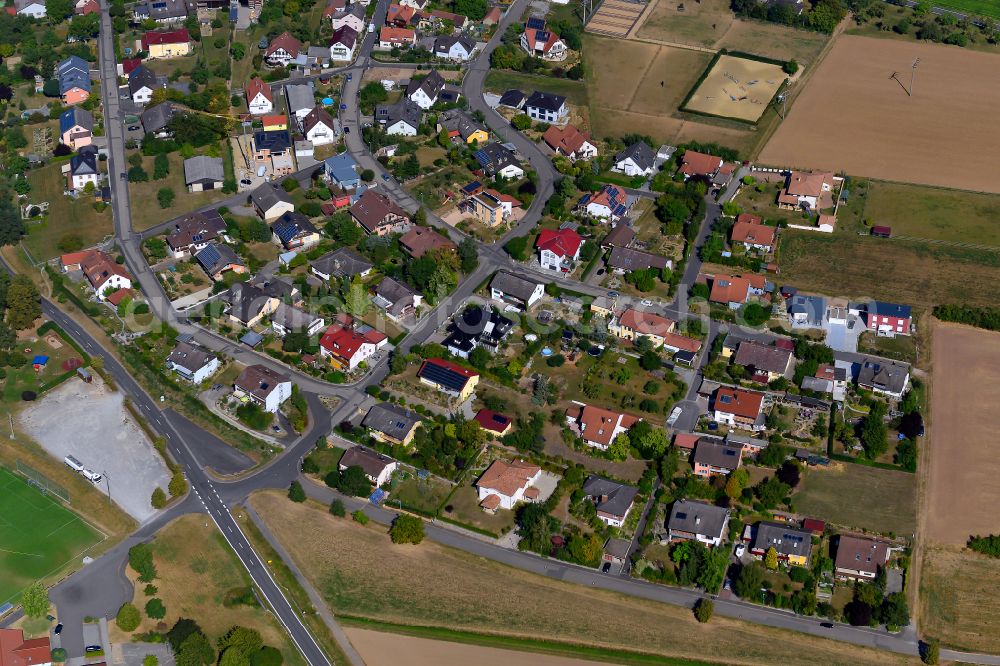 Bütthard from above - Agricultural land and field boundaries surround the settlement area of the village in Bütthard in the state Bavaria, Germany