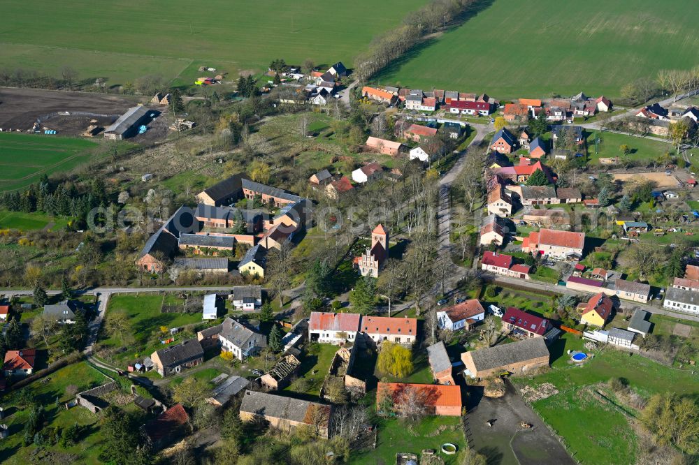 Buberow from above - Agricultural land and field boundaries surround the settlement area of the village in Buberow in the state Brandenburg, Germany